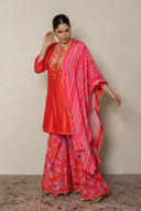 Coral kurta with tropical print pants andbeads embellishment